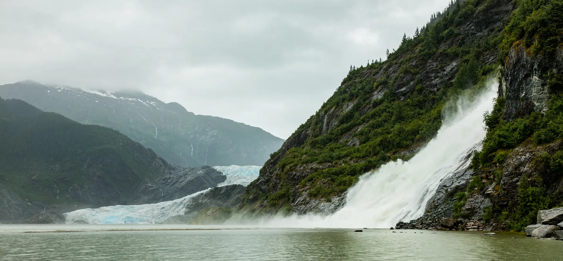 Mendenhall Glacier, proglacial lake, forested rock, and Nugget Falls near Juneau